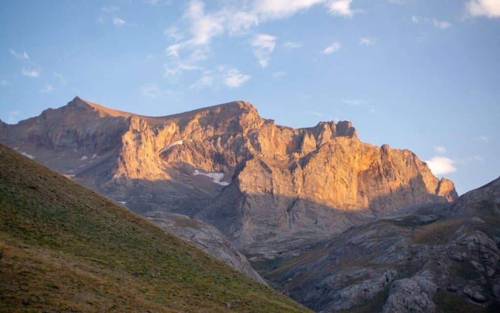 Sunrise illuminating a rugged mountain peak, representing growing awareness and visibility for men with anorexia