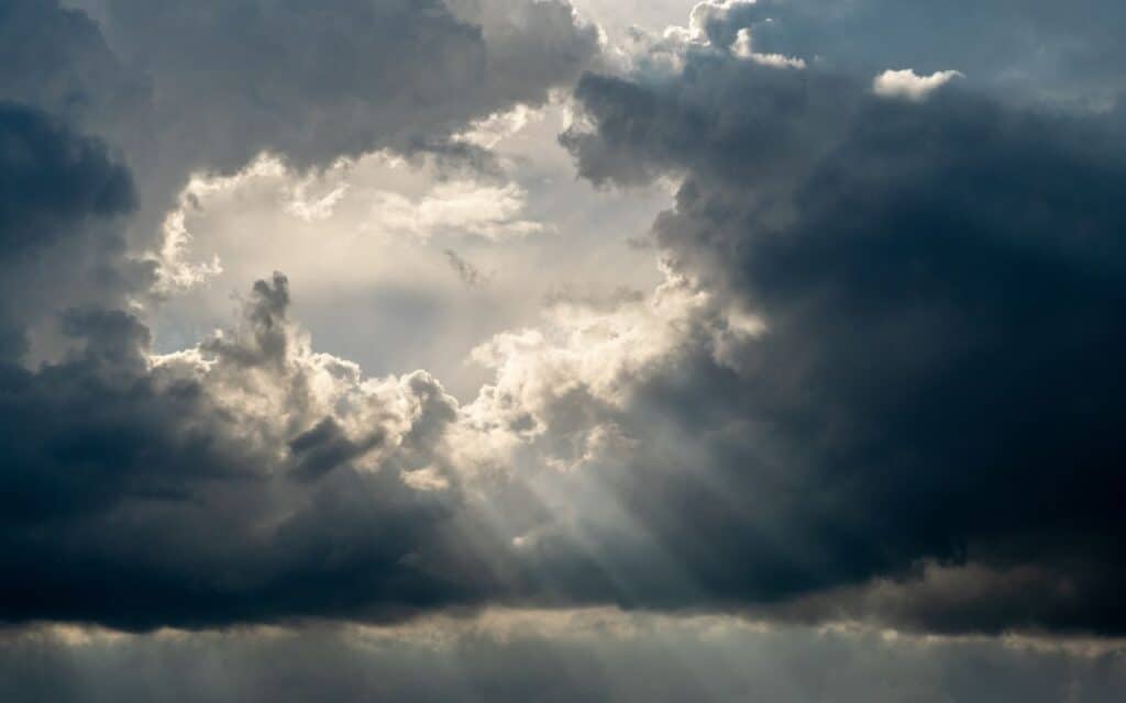 Sunlight breaking through rainclouds, representing hope and a clear path for how to deal with body dysmorphia