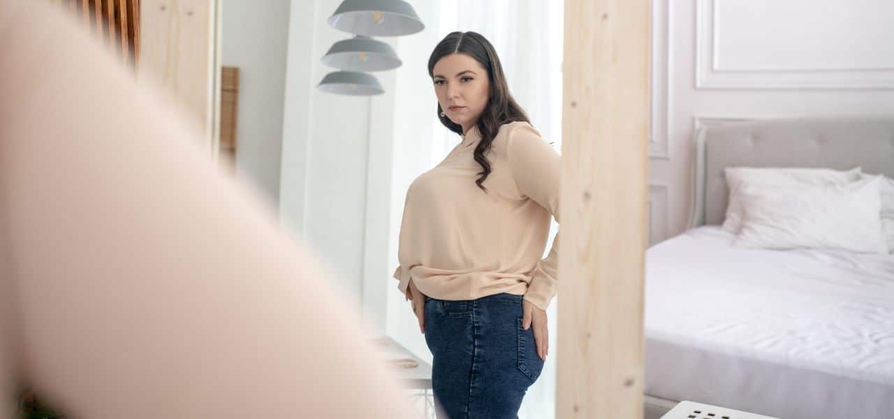 how to help someone with body dysmorphia - lady looking in the mirror
