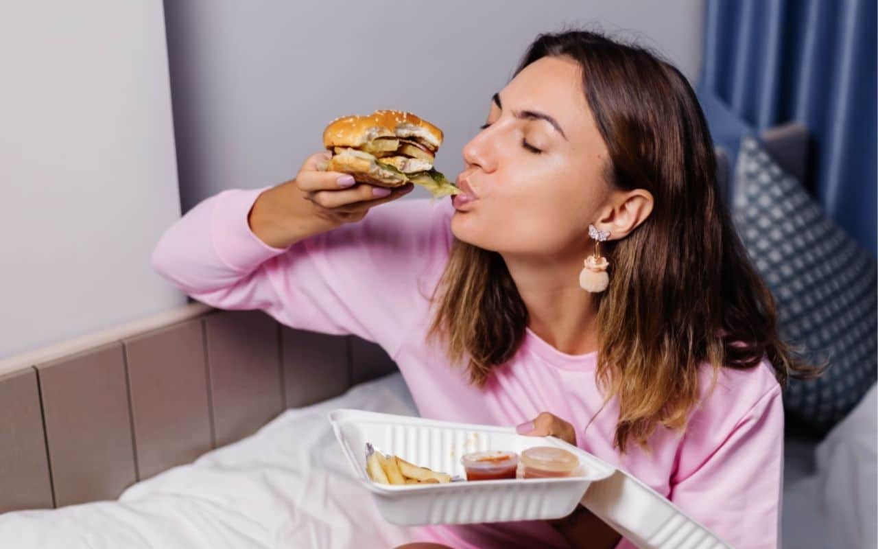 Binge eating and purging disorder - lady eating burger